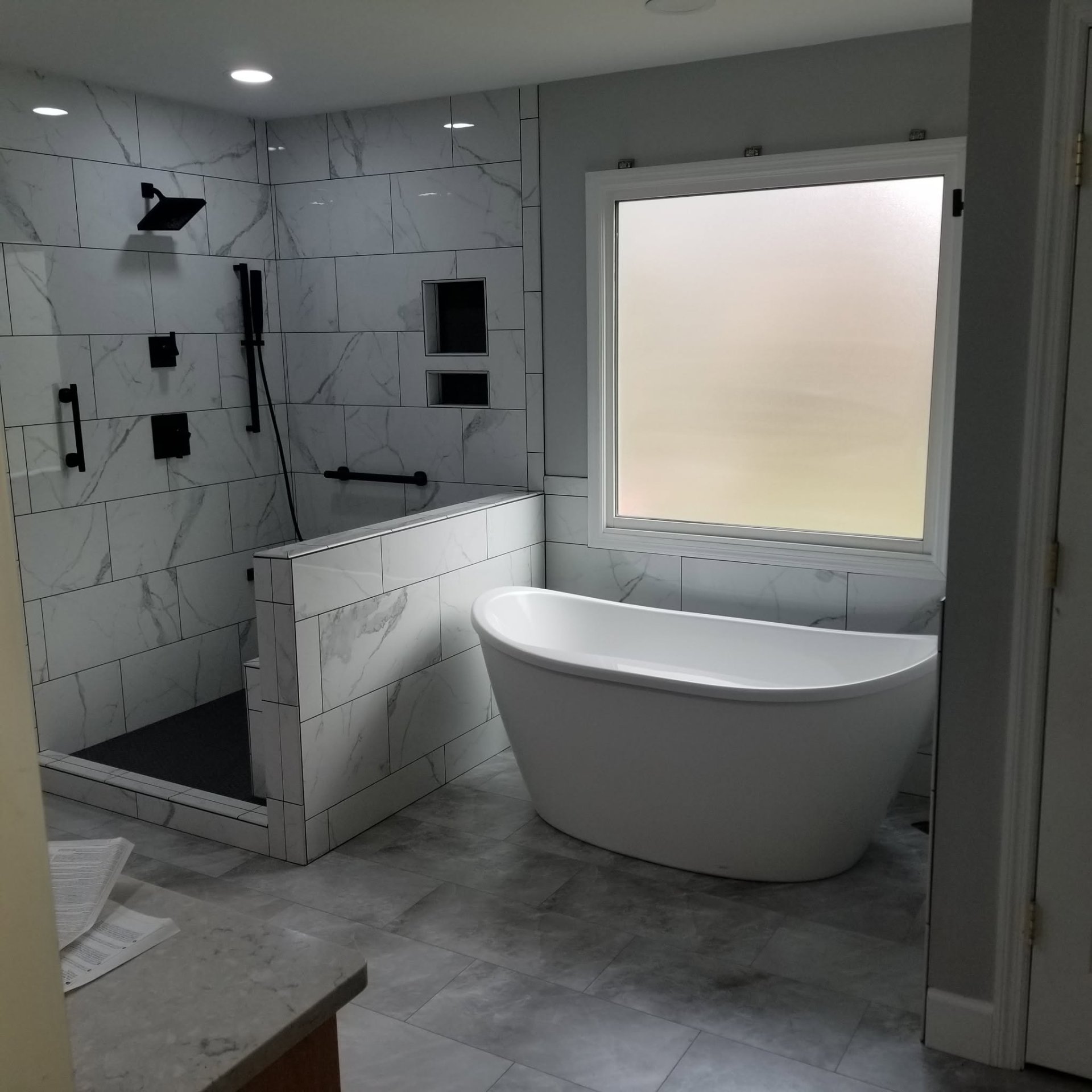 Marble bath with freestanding soaking tub and walk-in shower